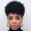 Woman with styled hair wearing gold hoop earrings against a neutral background, Obroi