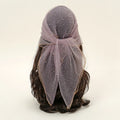 Headscarf with a bow on a wig against a plain background, Obroi