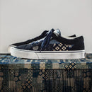 Pair of navy blue sneakers with white soles on a textured surface, featuring the 'Obroi' logo.