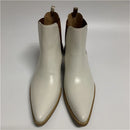 Pair of white ankle boots on a light gray background, Obroi