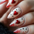 Nails with red heart and star designs on a white background, Obroi