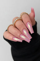 Hand with pink glittery nails and gold rings on a plain background, Obroi
