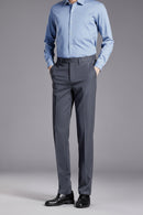 Person wearing a light blue shirt and gray pants on a gray background, Obroi