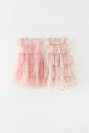 Two pink tiered dresses with gold star patterns on a white background, Obroi