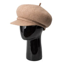 Beige beret on a black mannequin head against a white background, Obroi