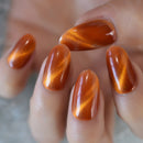 Close-up of a hand with orange nail polish on a neutral background, Obroi