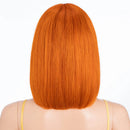 Orange wig on a mannequin head with a white background, Obroi