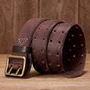 Brown leather belt with brass buckle on a wooden surface, Obroi
