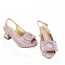 Pair of pink high-heeled shoes with embellishments on a white background, branded 'Obroi'.