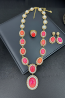 Necklace and earrings with pink and orange stones on a dark surface, Obroi