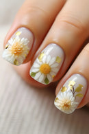 Nails with floral design featuring white flowers and gold accents on a light background, Obroi