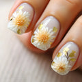 Nails with floral design featuring white flowers and gold accents on a light background, Obroi