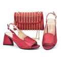 Red studded shoes and matching handbag on a white background, Obroi