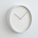 White wall clock with a minimalistic design on a light gray , Obroi