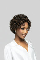Woman with short, curly hair wearing a white top against a gray background, Obroi