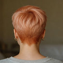 Person with short, styled hair from behind against a neutral background, Obroi