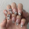 Nails with silver bow and heart designs on a light background, Obroi