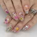Nails with colorful cartoon designs on a light background, Obroi