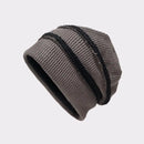 Knitted beanie hat with a ribbed texture on a light gray background, Obroi