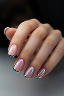 Hand with pink and silver nail polish on a dark background, Obroi