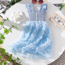 Blue floral dress on a white surface with decorative elements, Obroi