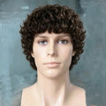 A mannequin bust wearing a short, curly brown wig against a soft gray-blue background, Obroi