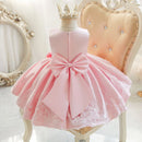 Pink dress with a large bow on a mannequin against a decorative background, Obroi