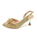 Gold high-heeled shoe with floral design on a white background, Obroi