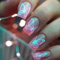 Nails with butterfly design in pink and green against a blurred background, Obroi