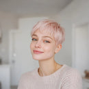 Person with pink hair wearing a light sweater indoors, Obroi