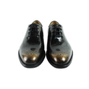Pair of black leather dress shoes with brown accents on a white background, Obroi