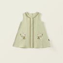 Light green sleeveless dress with floral embroidery on a beige background