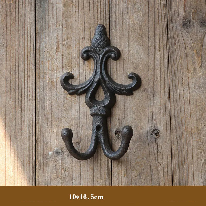 Decorative wall hook with intricate design on a wooden background, Obroi