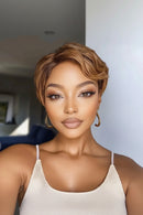 Woman with styled hair and makeup in a neutral setting, Obroi