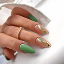 Obroi Hand with green nails and gold accents on a white background