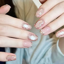 Close-up of hands with pink and clear floral nail design, Obroi