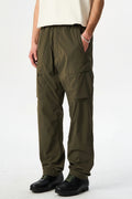 Person wearing olive green cargo pants on a white background, Obroi