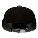 Black leather cap with a metal buckle on a white background, Obroi