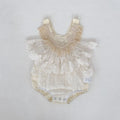 Baby romper with lace details on a light gray background, Obroi