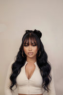 Woman with long, wavy hair styled in a high ponytail against a beige background, Obroi