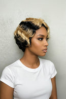 Woman with a styled haircut wearing a white shirt against a neutral background, Obroi