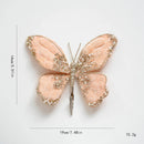 Butterfly-shaped decorative item with glittery details on a white background, Obroi