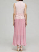 Pink dress with pleated skirt on a plain background, Obroi