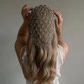 Person with long blonde hair wearing a decorative headpiece against a neutral background, Obroi