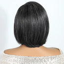 Back view of a person with a short black bob haircut on a white , Obroi