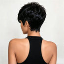 Short black wig with a layered, textured pixie cut shown on a model from the back, wearing a black halter top against a light gray background, Obroi