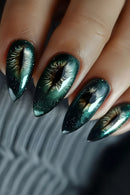 Close-up of a hand with green and gold nail art on a neutral background, Obroi