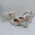White wedding shoes with decorative elements on a light gray background, Obroi