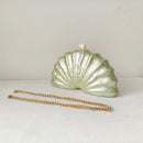 Shell-shaped clutch with a pearl on top and gold chain on a white background, Obroi