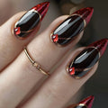 Nail art with red and black design on a blurred background, Obroi